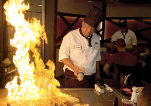 Eat What You Want Day - Chef preparing meals on a hibachi grill.