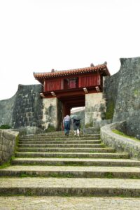 Two people walk up an outdoor staircase in Okinawa, where hara hachi bu originated. 